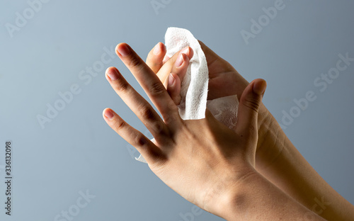 Wipe to disinfect or clean hands with a damp cloth on a black background