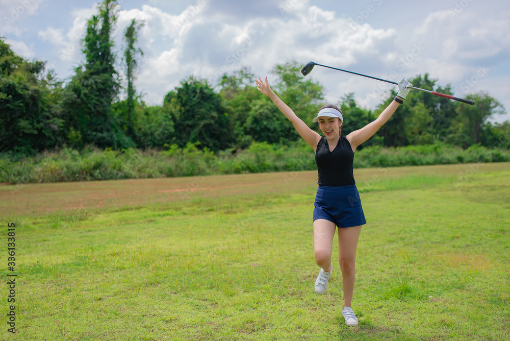 Portrait of golfer asian woman holding golf wood at the country club,Happy woman concept Portrait of golfer asian woman holding golf wood at the country club,Happy woman concept