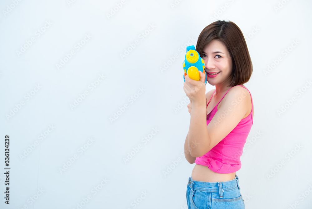 Asian sexy woman with gun water in hand on white background,Festival songkran day at thailand,The best of festival of thai,Land of smile Asian sexy woman with gun water in hand on white background,Festival songkran day at thailand,The best of festival of thai,Land of smile