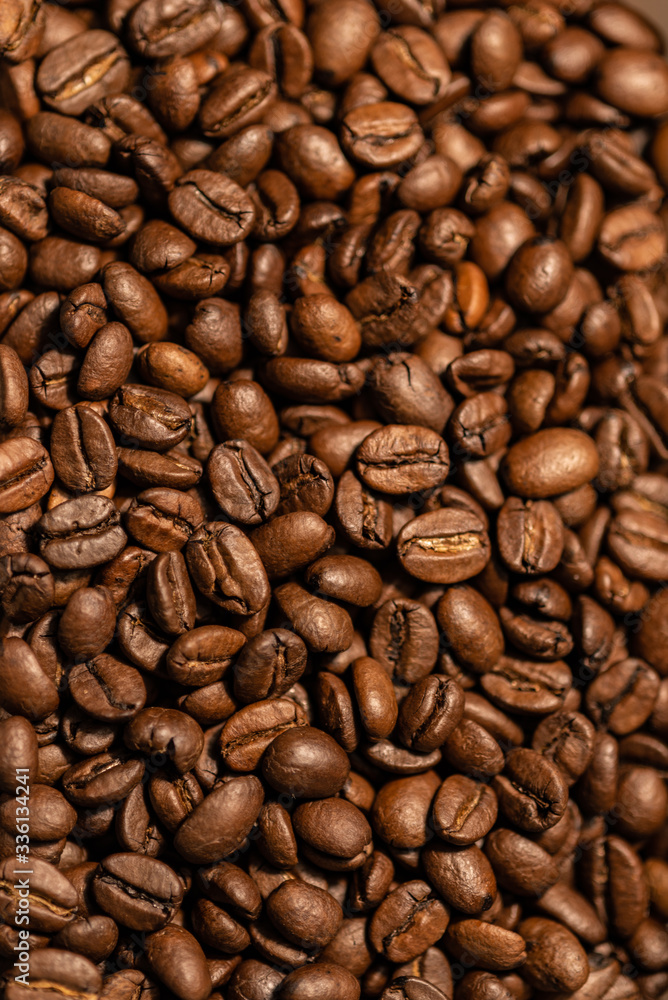 Grains of fresh roasted coffee close-up against a dark background. Coffee beans texture Grains of fresh roasted coffee close-up against a dark background. Coffee beans texture