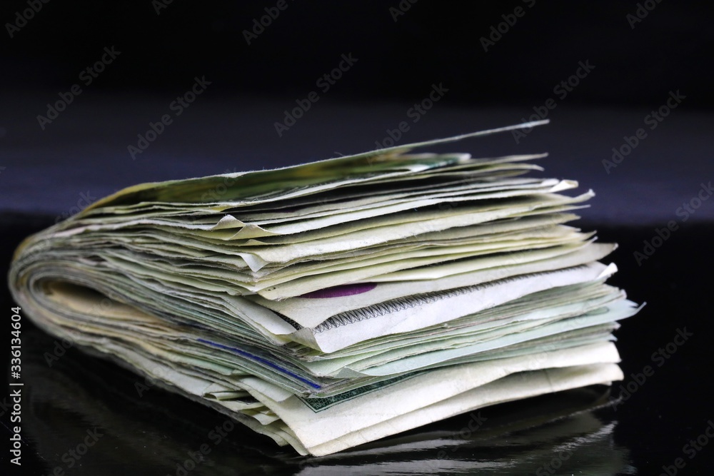 Wad of US cash on black background Wad of US cash on black background