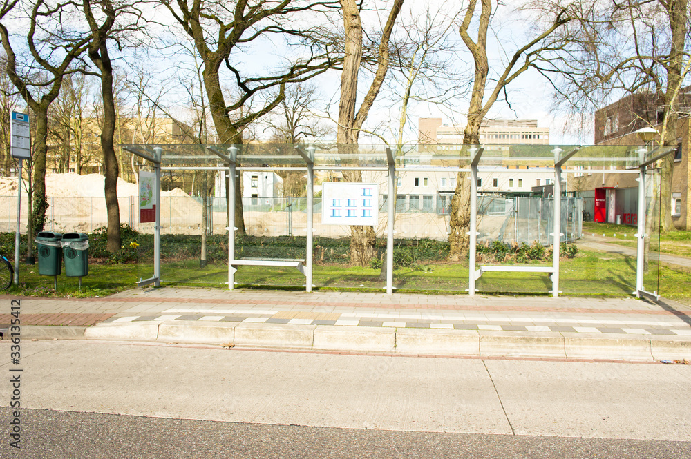 Bus stop for public transport with trees in the background in Nijmegen, Netherlands Bus stop for public transport with trees in the background in Nijmegen, Netherlands