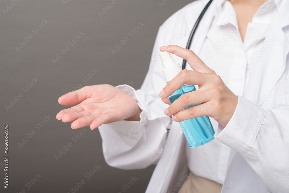 woman doctor is using hand sanitizer woman doctor is using hand sanitizer