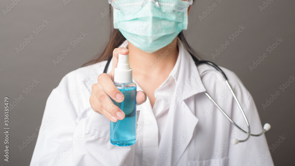 woman doctor is using hand sanitizer woman doctor is using hand sanitizer