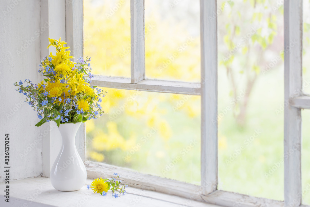 dandelions and forget-me-not in vase on windowsill dandelions and forget-me-not in vase on windowsill