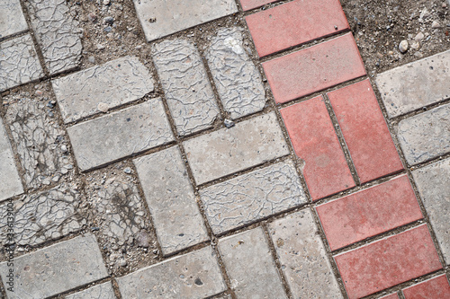 Background image of texture of pedestrian footpath covered by paving tiles