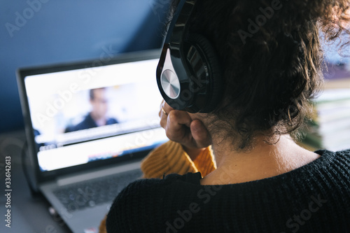 woman with headphones watching a movie on laptop photo