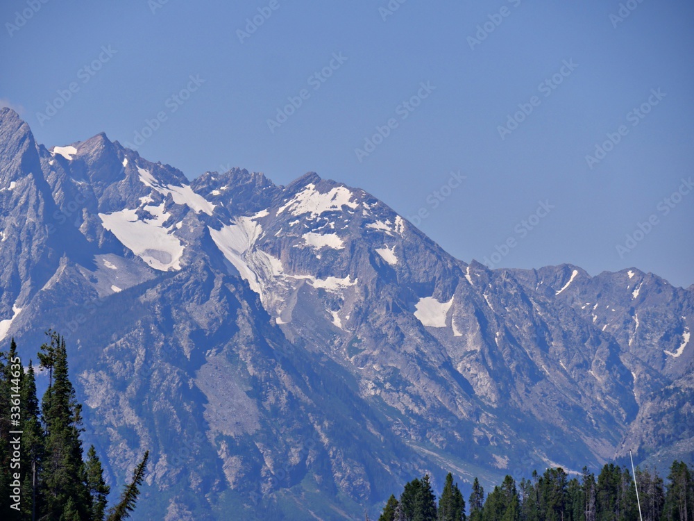 Distant view of the rugged mountain sides with snow at the Grand Teton National Park.