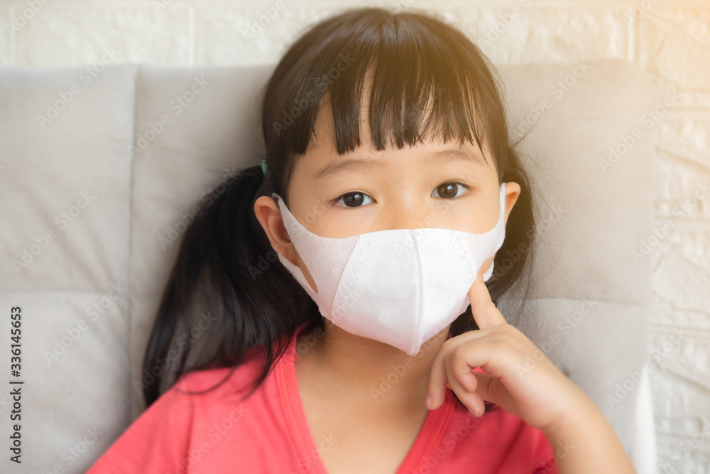 Little girl wearing mask for protect pm2.5 and Covid-19,sadness child at home in isolation,Coronavirus and Air pollution pm2.5 stop corona virus outbreak.Wuhan coronavirus and epidemic virus symptoms. Little girl wearing mask for protect pm2.5 and Covid-19,sadness child at home in isolation,Coronavirus and Air pollution pm2.5 stop corona virus outbreak.Wuhan coronavirus and epidemic virus symptoms.