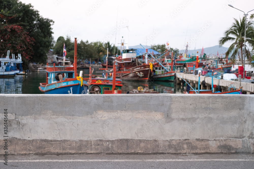 Concrete wall. Local fisherman port, fisherman boat mooring. Fisherman village near Pattaya beach, Thailand. ASEAN. South East Asia