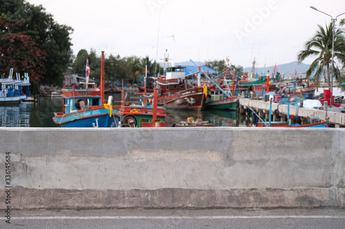 Concrete wall. Local fisherman port, fisherman boat mooring. Fisherman village near Pattaya beach, Thailand. ASEAN. South East Asia