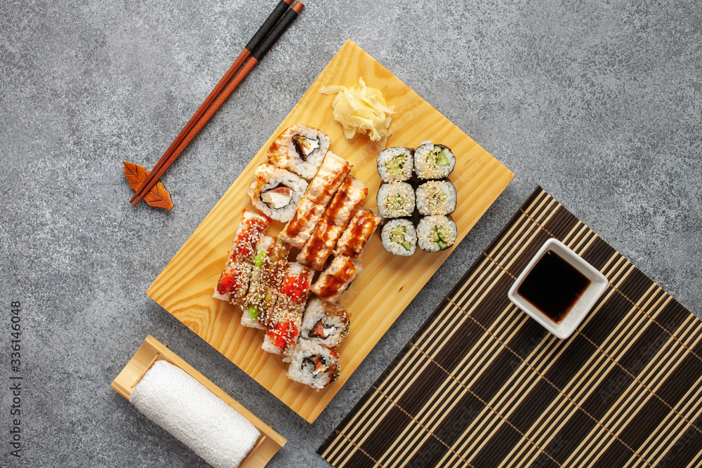 Set of sushi and maki with soy sauce over stone background. Top view Set of sushi and maki with soy sauce over stone background. Top view