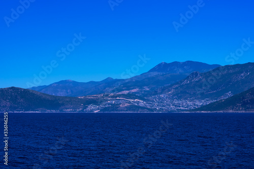 View of calm Mediterranean sea with mountain, rocky islands. Seascape with montains and blue water