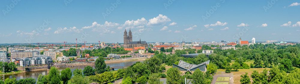 Panoramic bird view of Elbe river, old and new town, cathedral and city park in Magdeburg, Germany, summer, blue sky
