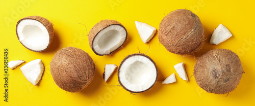 Flat lay with coconut on yellow background, top view