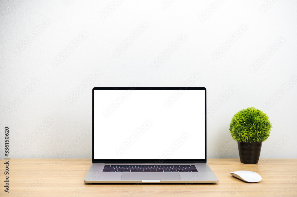 Laptop computer with white blank screen, mouse and decorated plant pot are on wood table, workspace mockup concept Laptop computer with white blank screen, mouse and decorated plant pot are on wood table, workspace mockup concept