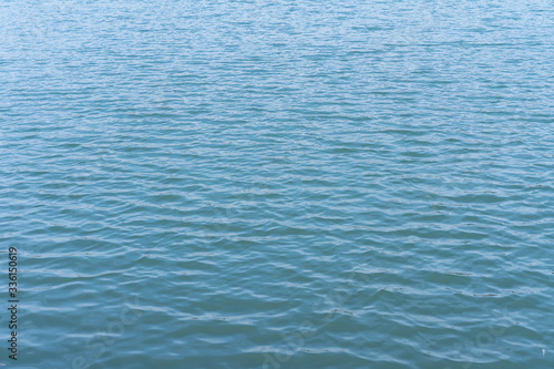 Sea surface of water with small waves from the wind