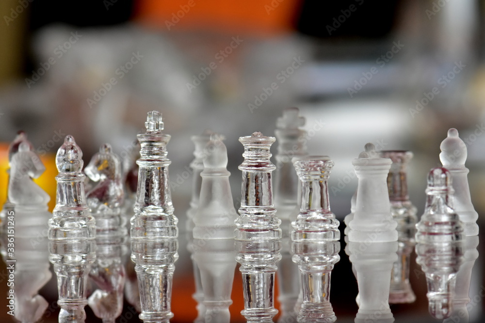 glass chess pieces on chess board glass chess pieces on chess board