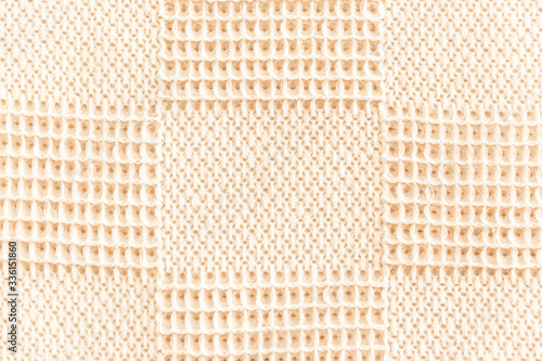 Beige textile texture background with waves and squares 