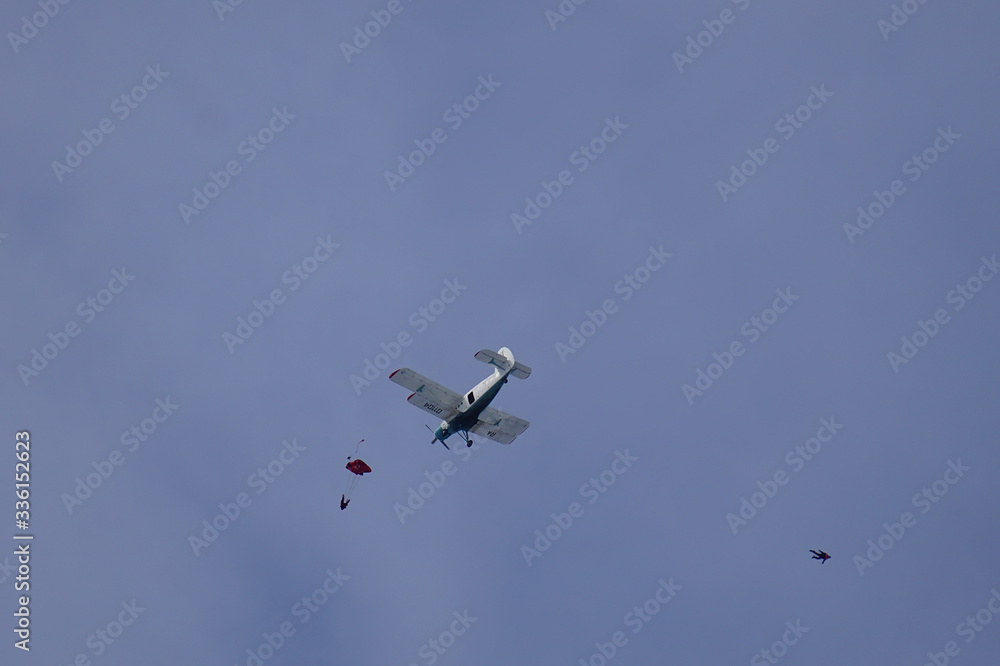 Two skydivers have just jumped out of an airplane. Skydivers parachuting down to the Earth.
