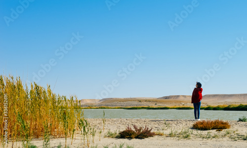 Young Asian girl playing around Ailike Lake at Karamay, Xinjiang, China