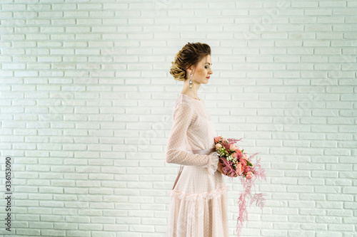 Portrait of a beautiful girl in a wedding dress. Photo in profile. photo