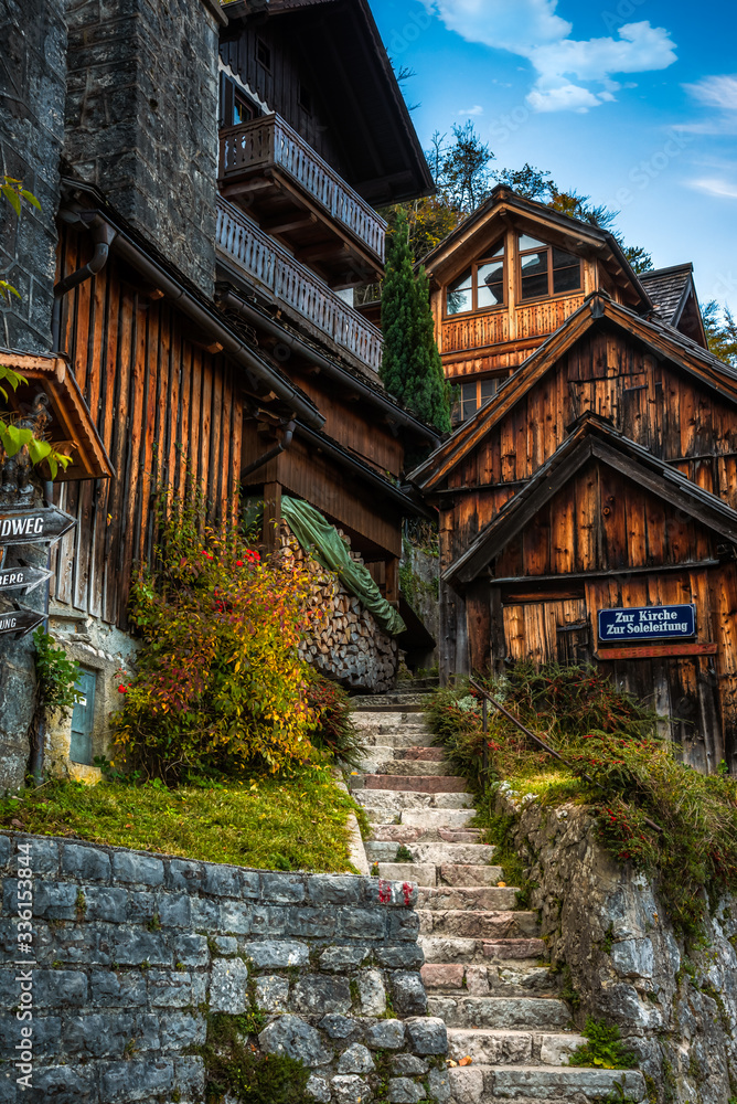 Traditional wooden houses and a narrow alley on the top of the stone stairs in the downtown of Hallstatt, Austria