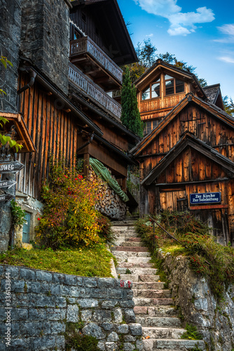 Traditional wooden houses and a narrow alley on the top of the stone stairs in the downtown of Hallstatt  Austria