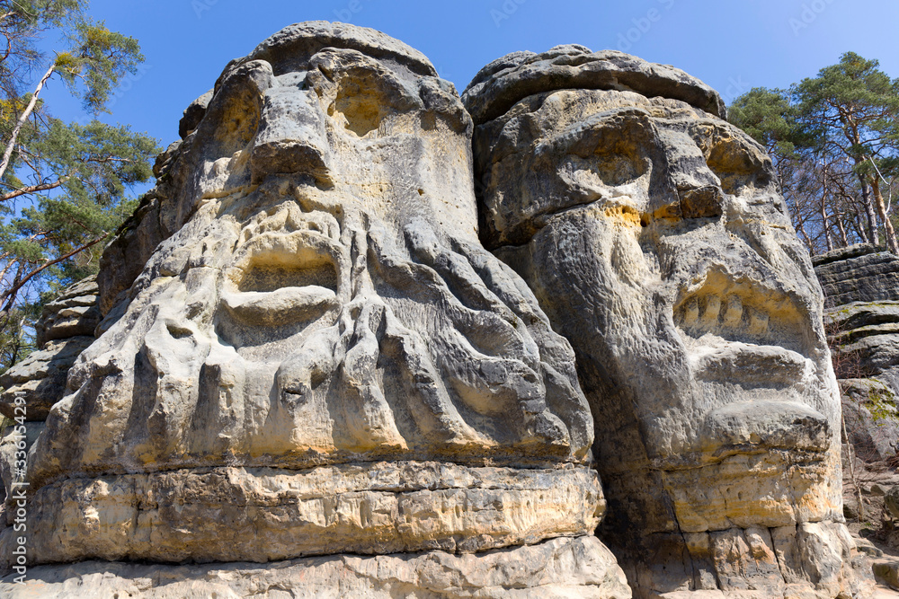 Devil's heads, monument sandstone sculptures from 19th century in northern Bohemia, Zelizy, Czech Republic