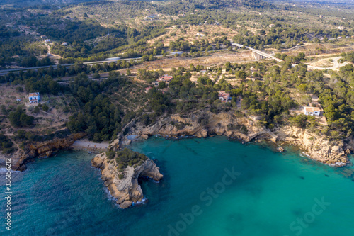 Fototapeta Naklejka Na Ścianę i Meble -  Aerial drone top-down view of calm turquoise water and rocks on the beautiful coast of Spain on the east side
