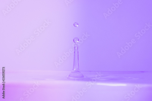 Moving water drop on a colorful background