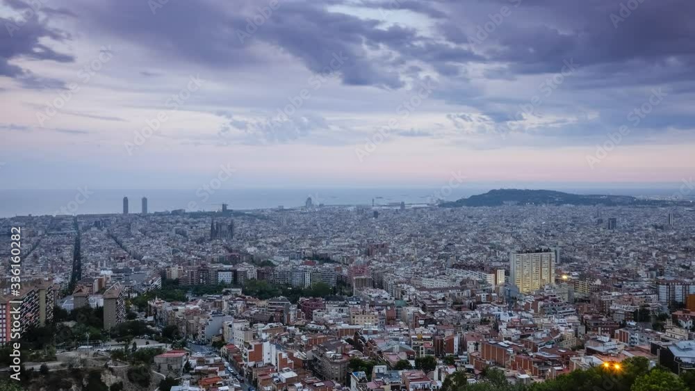 Sunset to night timelapse over the Skyline of Barcelona with cathedral Sagrada Familia and mountain Montjuic, from the top of Bunkers del Carmel, moving clouds in sky, Spain
Sunset to night timelapse over the Skyline of Barcelona with cathedral Sagrada Familia and mountain Montjuic, from the top of Bunkers del Carmel, moving clouds in sky, Spain