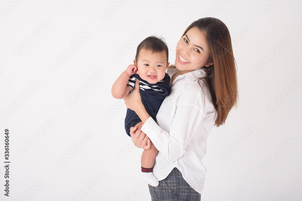 Happy newborn cute baby and beautiful mom in studio