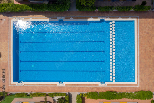 Aerial drone top-down photo of an Olympic sized leisure swimming pool located in a private residential area in spain
