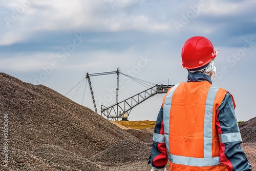 labor protection. Female hard work. harmful production. Work clothes, vest and helmet. photo