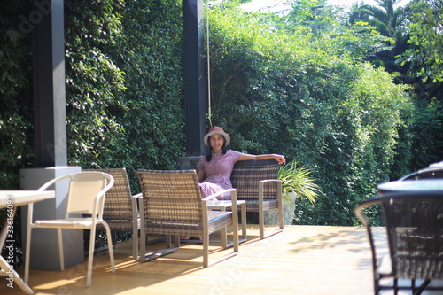 Woman sitting in a green garden