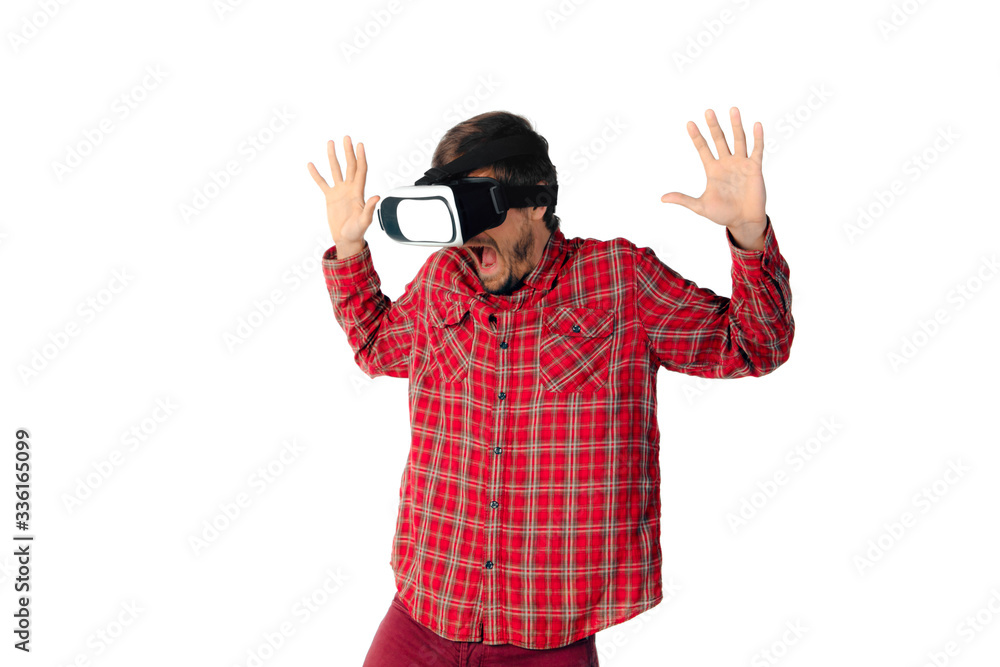 Young caucasian man emotional playing, using virtual reality headset isolated on white studio background. Concept of modern technologies, gadgets, tech, human emotions, advertising. Copyspace. AR, VR. Young caucasian man emotional playing, using virtual reality headset isolated on white studio background. Concept of modern technologies, gadgets, tech, human emotions, advertising. Copyspace. AR, VR.