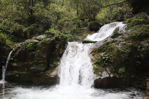Fototapeta Naklejka Na Ścianę i Meble -  Beautiful landscape of a waterfall in a forest in a Mountain in Sichuan, China