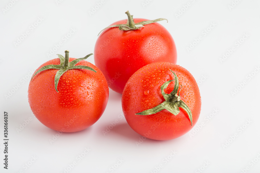 Beautiful juicy red tomatoes on a white background Beautiful juicy red tomatoes on a white background