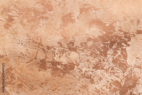 Peachy texture with gold paint leaks and stains. Craft Background.