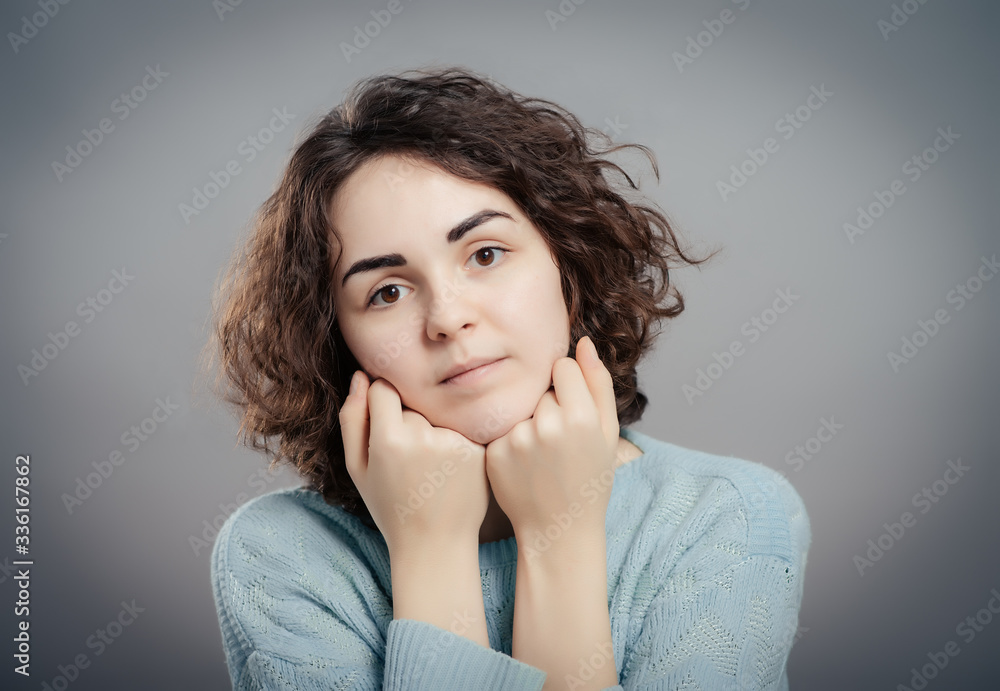 Beautiful sad casual lady isolated on gray background Beautiful sad casual lady isolated on gray background