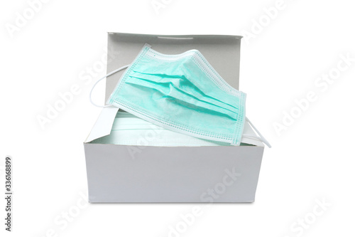 Pack of ear loop medical masks in box with medical mask on top isolated on white background with clipping path. anti virus and bacteria protective face air pollution, protection concept.