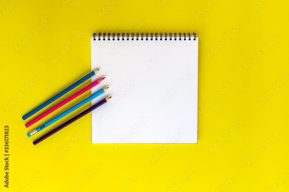 Notepad on a yellow background. Notepad on a yellow background.
