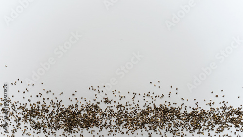 top view of line of chia seeds on a white background. Banner format 