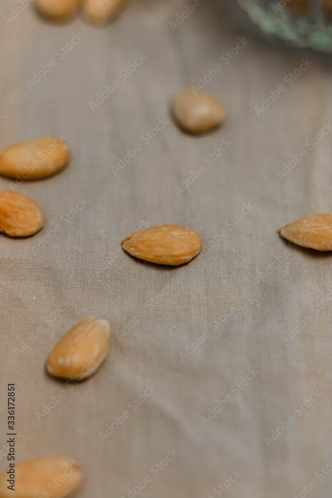 Bowl of toasted almonds on a gray background Bowl of toasted almonds on a gray background