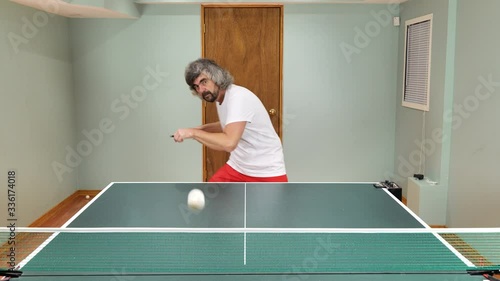Man playing table tennis with robot automatic feed balls system