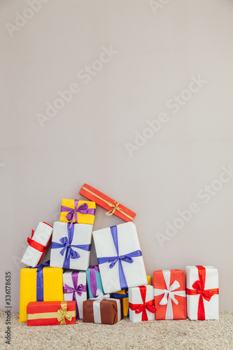 lots of multi-colored gifts on a gray background