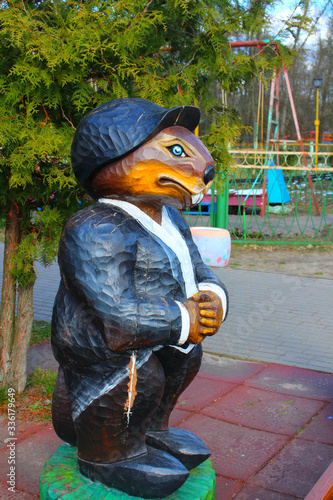 Wooden figurine of a beaver dressed in a black suit photo