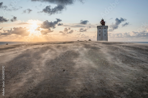 Denmark, Lonstrup, Rubjerg Knude Lighthouse at sunset photo