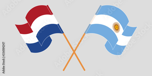 Crossed and waving flags of Argentina and the Netherlands